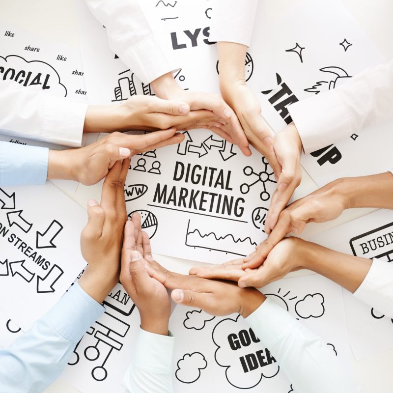 Business people making circle out of hands to emphasize digital marketing concept